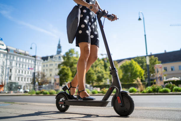 E-scooter on the streets of Vienna Woman riding an Electric scooter on the streets of Vienna